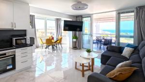 a living room with a couch and a table at AZURE VIEW Ponderosa 719 in Playa Fañabe