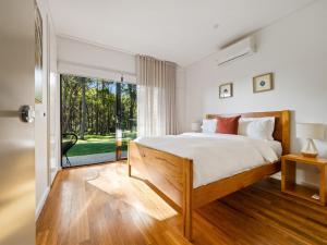 a bedroom with a bed and a large window at Simala Retreat in Cowaramup