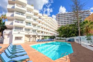 a swimming pool in front of a building at AZURE VIEW Ponderosa 719 in Playa Fañabe
