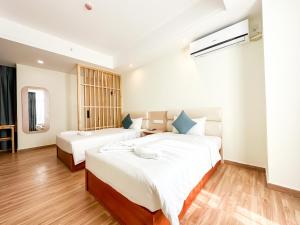 En eller flere senger på et rom på Landmark Vientiane Life Center