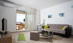 a living room with a couch and a table at Apartments Medvid in Trogir