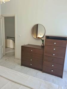 a dresser with a mirror on top of it at DM Villa - quality stay in Perea, Thessaloniki, Greece in Perea