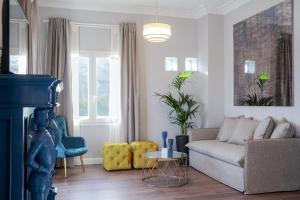 a living room with a couch and a table at Pafsilipon Suites in Ermoupoli