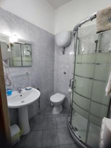 a bathroom with a toilet and a sink and a shower at Albergo Primavera in Porto Cesareo