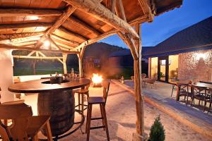 a patio with a table and chairs and a wine barrel at MAGNETIC HOUSE in Târgu Ocna