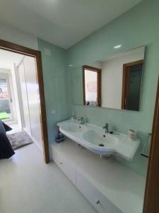 a bathroom with a sink and a mirror at Alojamiento de relax y romanticismo ! in Bueu