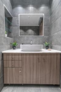 a bathroom with a sink and a mirror at Aurora Apartment, Room 2 - Cozy, close to the beach in Marmari