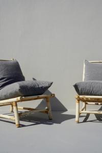 two chairs with pillows sitting next to each other at Pafsilipon Suites in Ermoupoli