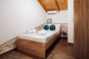 a bedroom with a large bed with blue pillows at Achilleas cozy house in Prinés