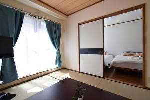 a bedroom with a large mirror and a bed at メゾン八千代102 in Tokyo