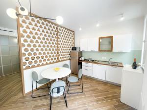 A kitchen or kitchenette at Taonasi Taormina City Apartment