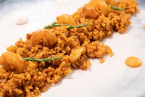 a pile of rice on a white plate at Melia Alicante in Alicante