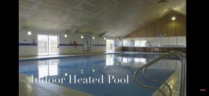 a large indoor heated pool in a building at 192 Rickardos Holiday Lets 3 Bedroom caravan near Mablethorpe in Saltfleet