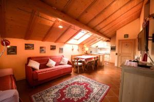 a living room with a red couch and a table at Chalet Alfonz in Bormio