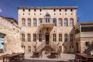 a large brick building with tables and chairs at Anadolu Evleri in Gaziantep