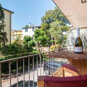 a bottle of wine sitting on a table on a balcony at enJoy Home - Bilocale sulle Riviere a due passi dalla Specola in Padova