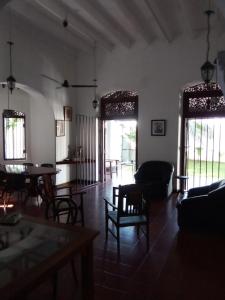 a living room with a couch and a table and chairs at College House Close to Fort in Colombo