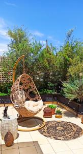 a wicker chair sitting on top of a patio at Accessible Luxury in Artemida