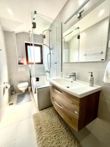a bathroom with a sink and a shower and a toilet at Villa Serenity Budva in Budva +55 photos
