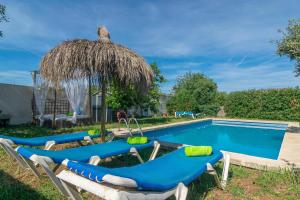 a group of lounge chairs next to a swimming pool at Son Blau in Llucmajor