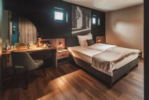 a bedroom with a bed and a desk and a desk at Mediterraneo Luxury Room Esztergom in Esztergom