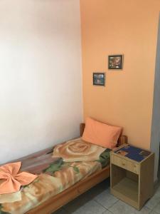 a small bedroom with a bed and a table at Oregon in Paralia Katerinis