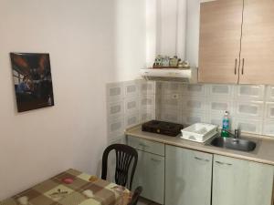 a small kitchen with a sink and a table at Oregon in Paralia Katerinis