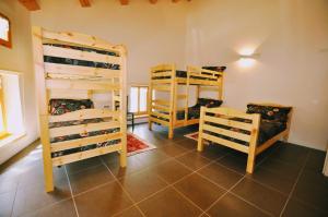 a room with two bunk beds and two chairs at Museo Ostello 