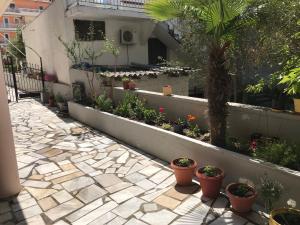 a courtyard with potted plants and a building at Oregon in Paralia Katerinis