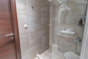 a bathroom with a shower and a sink at Aurora apartments Room 1 in Marmari