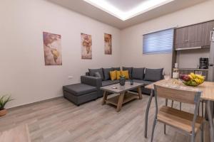 a living room with a couch and a table at Aurora apartments Room 1 in Marmari +16 photos