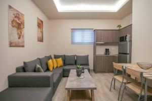 a living room with a couch and a table and a kitchen at Aurora apartments Room 1 in Marmari