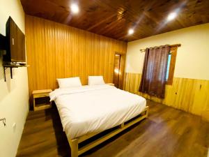 Cama ou camas em um quarto em Manasau Resort