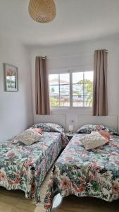 1 dormitorio con 2 camas y ventana en Tropical Apartment - Heated Pool en El Palmar