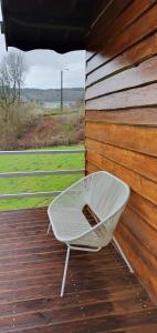 a white chair sitting on a wooden deck at Chalet Les Allores Dohan (Bouillon) in Bouillon +16 photos