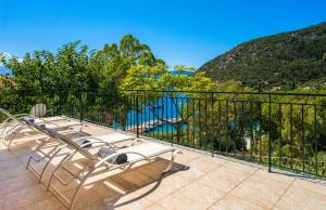 a balcony with chairs and a view of a mountain at Lemonia Beach Villa in Stavros