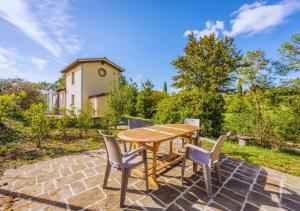 a wooden table and chairs on a stone patio at CountryHouse con Piscina Privata Vicina al Centro in Florence