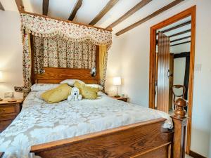 a bedroom with a bed with a stuffed animal on it at Northgate Bakery Annex in Beccles