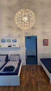 a bedroom with a bed and a chandelier at Studio Luka in Crikvenica