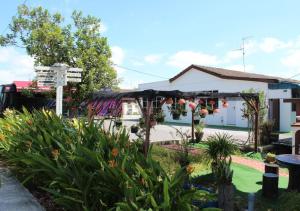a garden in front of a house with a pergola at RV @ U GARDEN STAY in Skudai