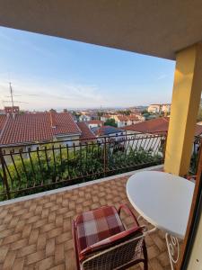 a balcony with a table and chairs and a view at Apartma Stimec Izola in Izola