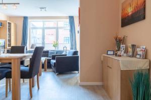 a room with a table and chairs and a living room at Villa Marin Wohnung 02 in Zinnowitz +22 photos