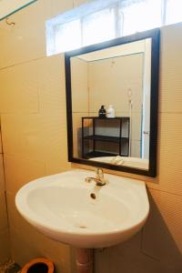 a bathroom with a sink and a mirror at Coconut Suite in General Luna