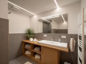 y baño con lavabo y espejo. en Appartement Am Hof Untertann en Kirchberg in Tirol