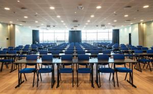 a large room with tables and blue chairs at Thon Hotel Ski in Ski