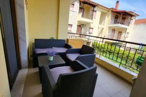 a balcony with two chairs and a table on a balcony at Afytos Teo House in Kassandria