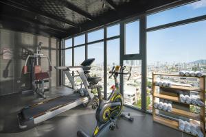 a gym with two exercise bikes in a room with windows at Estrella Boutique Hotel in Da Nang