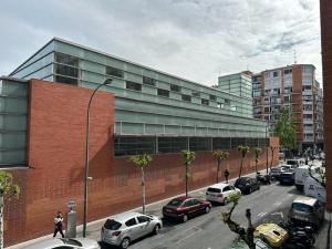 a parking lot with cars parked in front of a building at Areilza by Forever Rentals in Bilbao