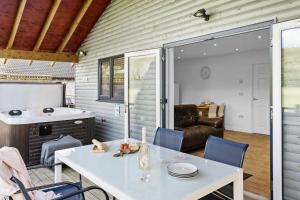 a kitchen and dining room with a white table and chairs at Kingfisher Lodge, Redlake Farm, Nr Glastonbury in Somerton +22 photos