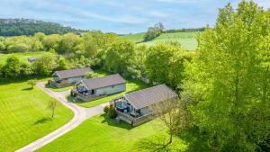 an aerial view of three cottages in a field at Kingfisher Lodge, Redlake Farm, Nr Glastonbury in Somerton